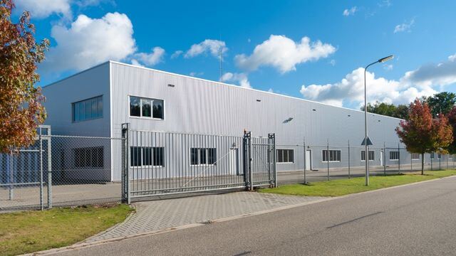 Commercial warehouse facility secured with perimeter fencing and controlled gate access for industrial property protection in Stockton, CA