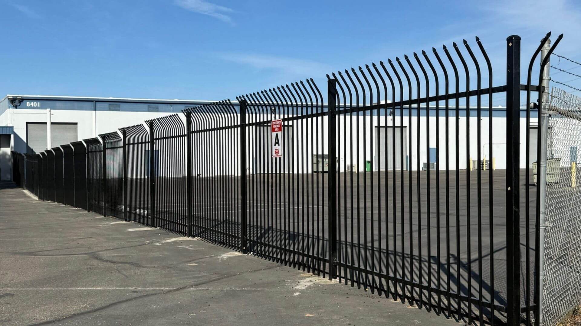 Anti-climb steel security fencing surrounding commercial warehouse facility in Sacramento California