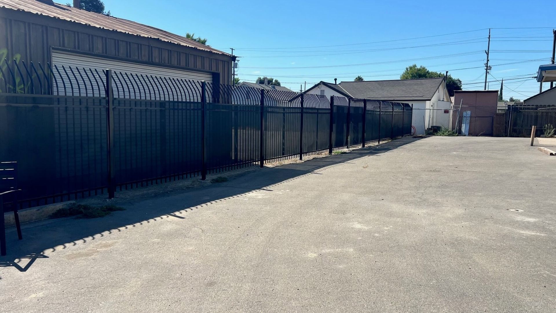 Iron security fencing with curved pickets and privacy screening at Hannah’s House