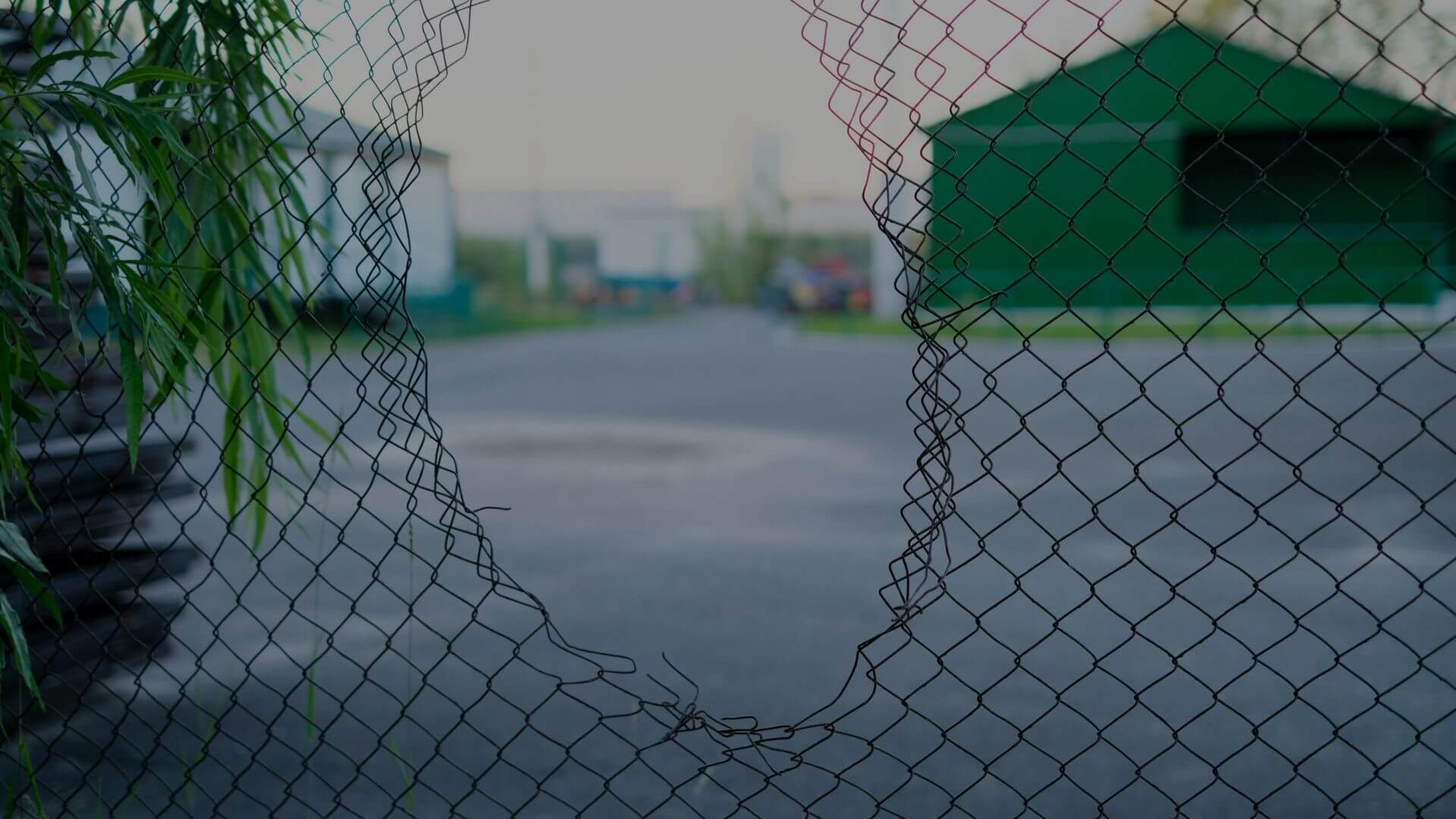 Damaged chain link fence with large opening creating a security vulnerability at a commercial or industrial property in Stockton, CA