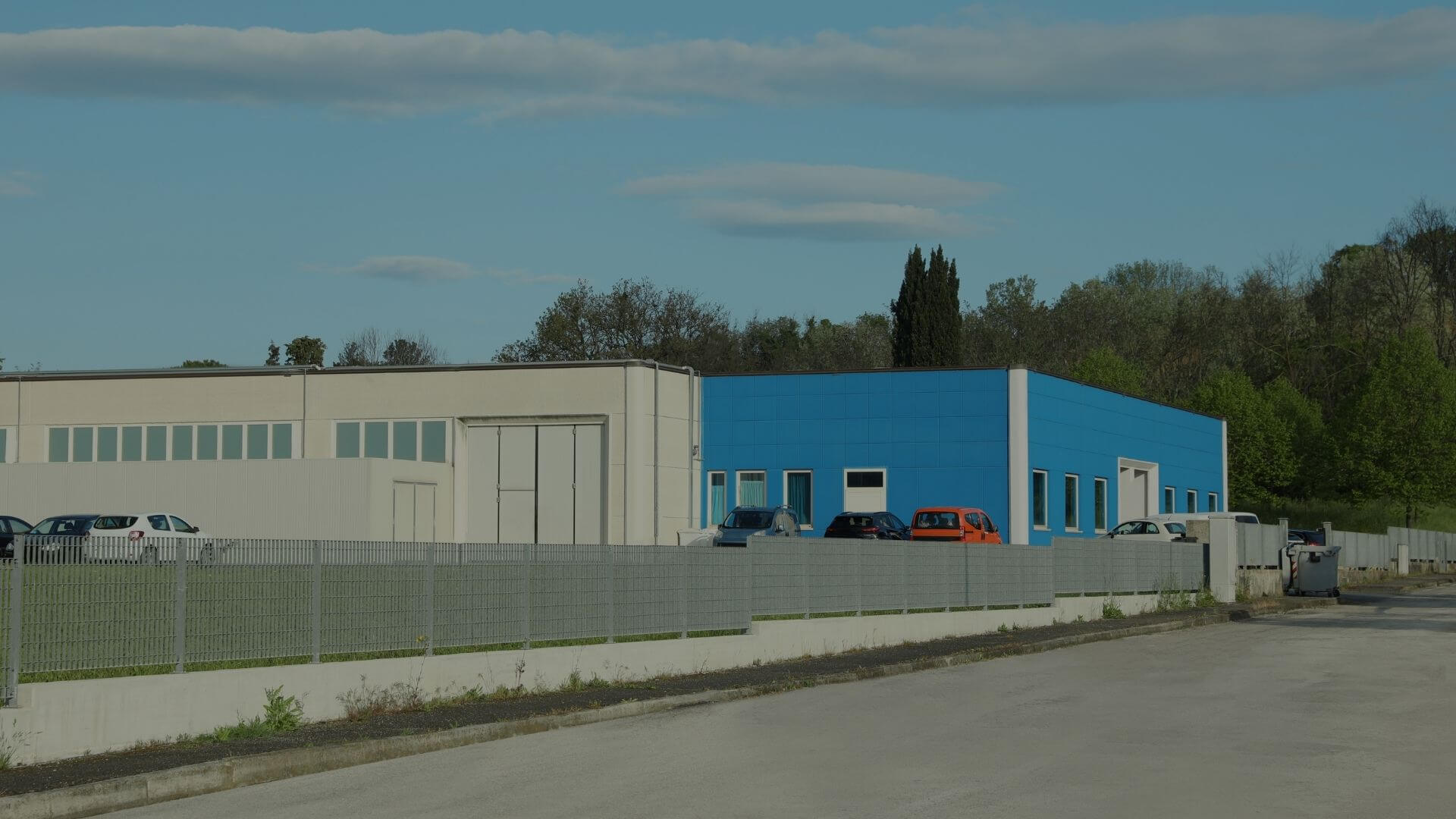 Commercial warehouse facility surrounded by secure perimeter fencing, demonstrating property protection and access control for industrial sites in Stockton, CA