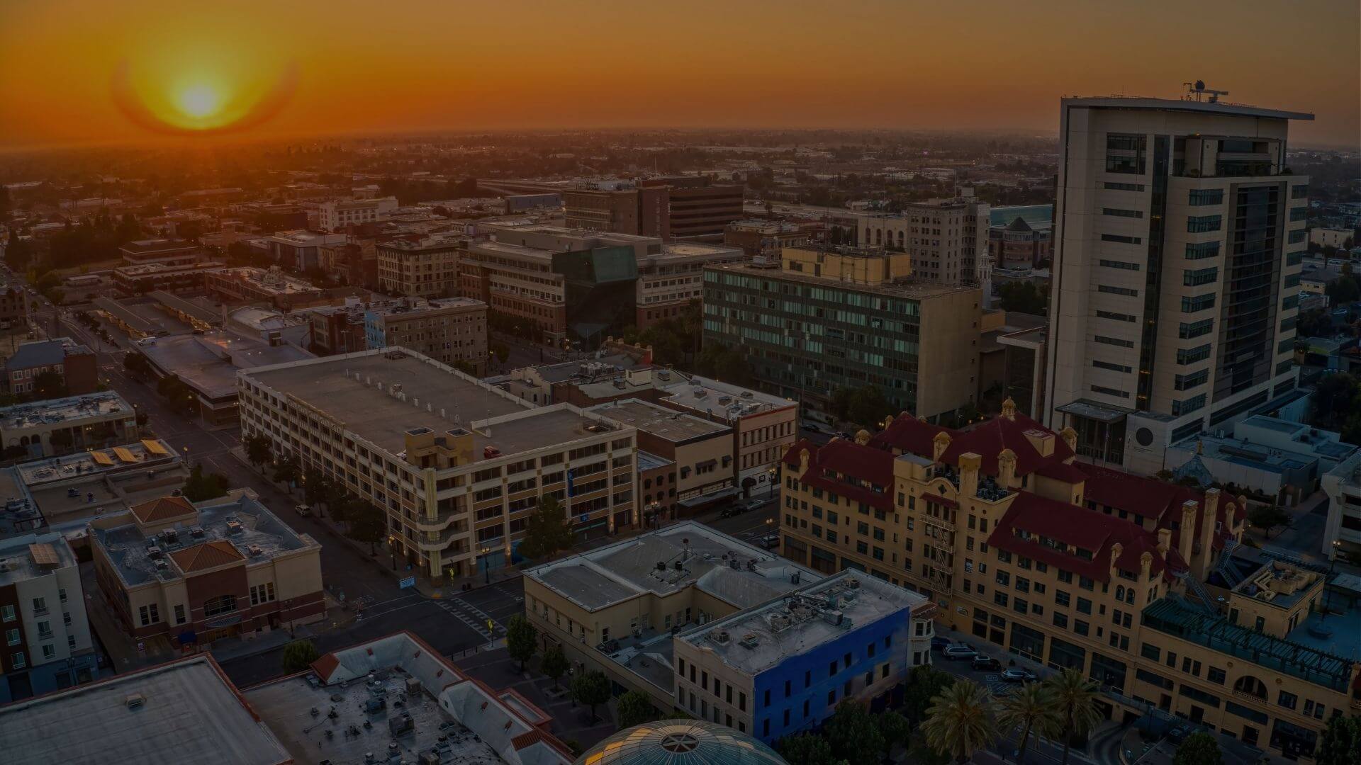 Downtown Stockton, California skyline at sunset featuring commercial buildings, business district, and growing Central Valley economy
